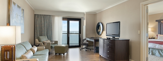 the living room and king bedroom with flat screen tv and balcony looking over lake ray hubbard at the hilton dallas rockwall hotel