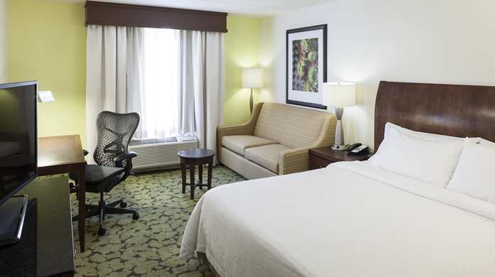 the guestroom at the hilton garden inn duncanville tx with king bed and sitting area