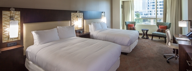 this guest room at the hilton granite park in plano tx has 2 queen beds with white comforters