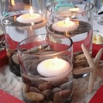 have a beach themed wedding reception with candles, shells, sand and rocks at the hilton lake ray hubbard in rockwall