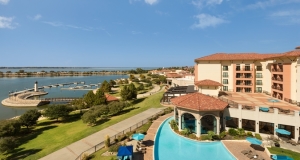 a beautiful outdoor view of hilton in rockwall tx showing pool paved trail and lake ray hubbard