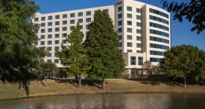 outside view of the Granite Park Hilton with Water View and Green Trees