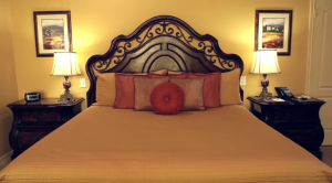 this king bed is beautifully appointed with pillows and makes a beautiful guestroom at the wildwood inn denton texas