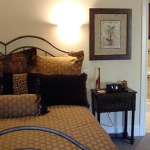 guestroom with king bed and whirlpool tub in the background at the wildwood inn denton tx