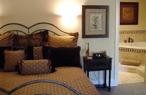 guestroom with king bed and whirlpool tub in the background at the wildwood inn denton tx