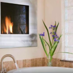 the guest bath with a 2 person Jetted Tub with Fireplace at the Inn on Lake Granbury Texas