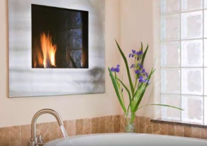 the guest bath with a 2 person Jetted Tub with Fireplace at the Inn on Lake Granbury Texas
