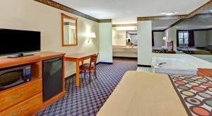 this suite includes a king bed along with ho tub and work desk at the super 8 motel arlington tx sw