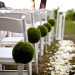wedding ceremony with white chairs and white rose petals outside of the inn on lake granbury texas