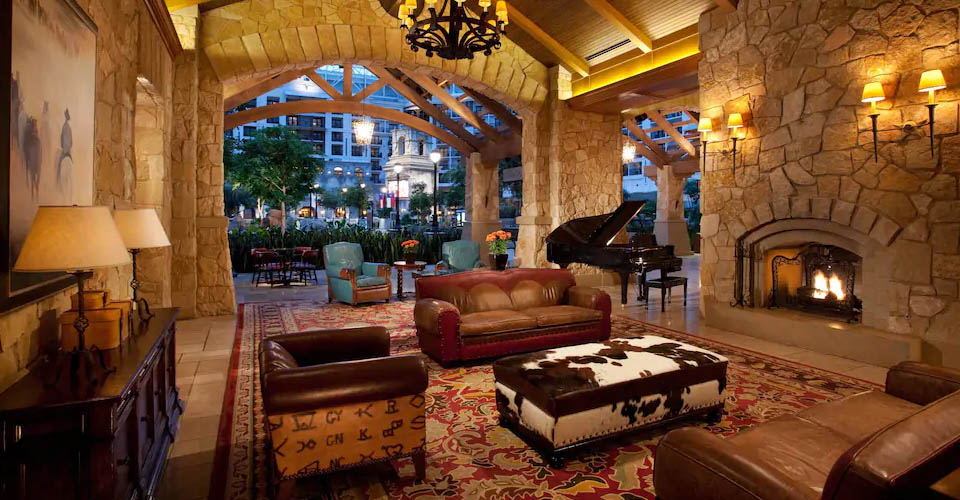 Lobby seating area with beautiful fireplace and grand piano of the Gaylord Texan 960