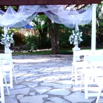 up close view of a wedding ceremony and white chairs at the wildwood inn denton tx