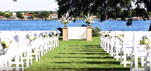 a beautiful wedding venue on the grass outside of the inn on lake granbury with a view of the lake