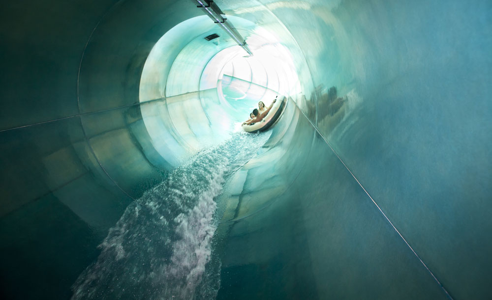 View of a long tube section with large tube with family riding on the River Canyon Ride 