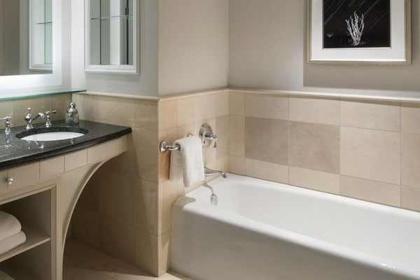 ritz carlton dallas has a beautiful and luxurious deep soaking tub in the guest bath of the Junior Suite