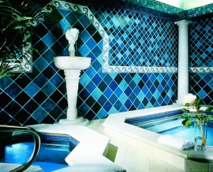 The spa at the Rosewood Crescent is filled with blue toned tiles and the warmth of a spa tub