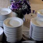 the white plates are stacked and ready for the wedding reception guests to arrive at the wildwood inn in denton